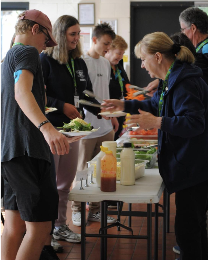 camp koala with kids lined up for food