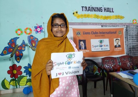 Girl holding a Sight for Kids sign